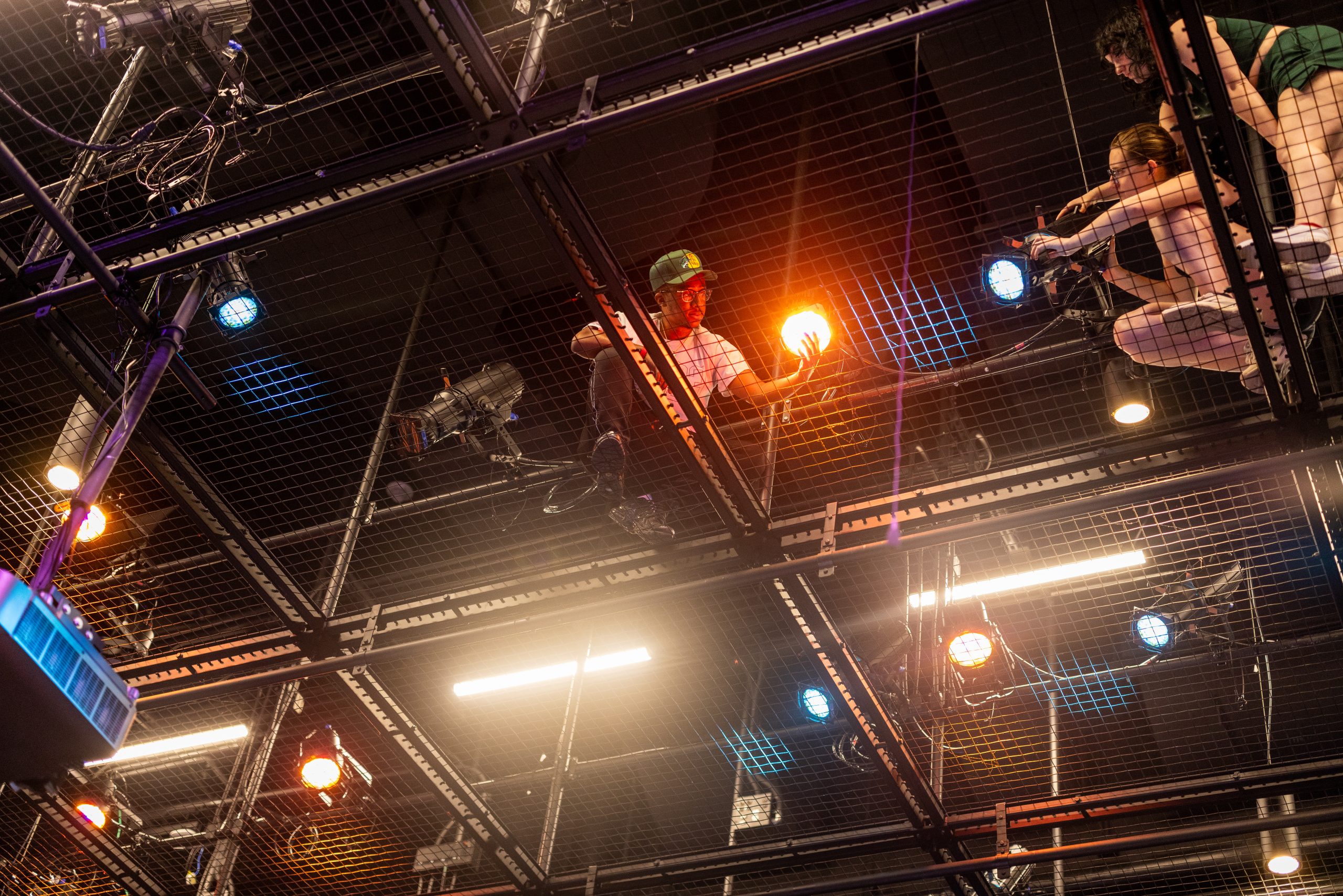 Students adjusting scene lighting in the theatre